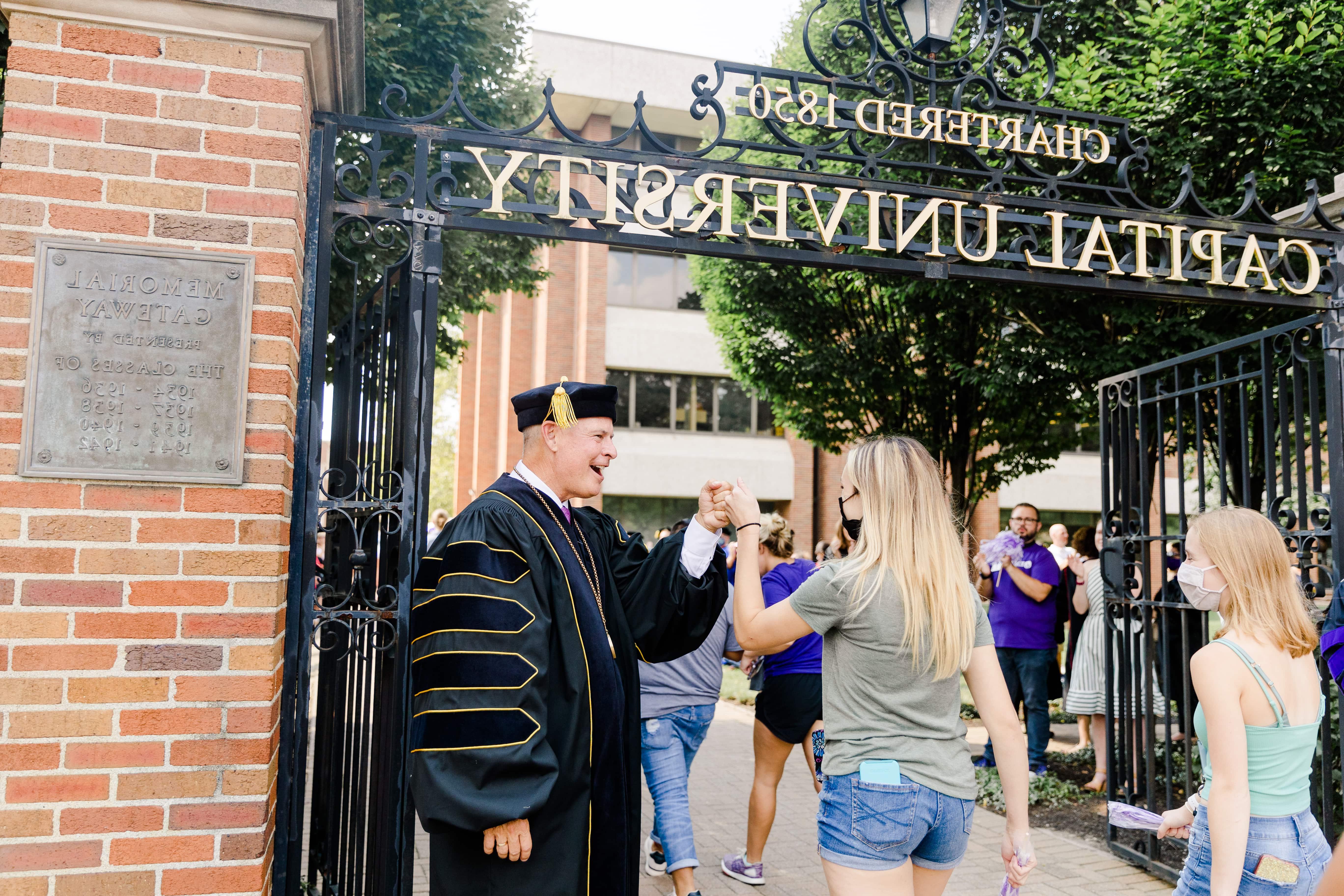 President Kaufman Fist Bumping Student At Gate